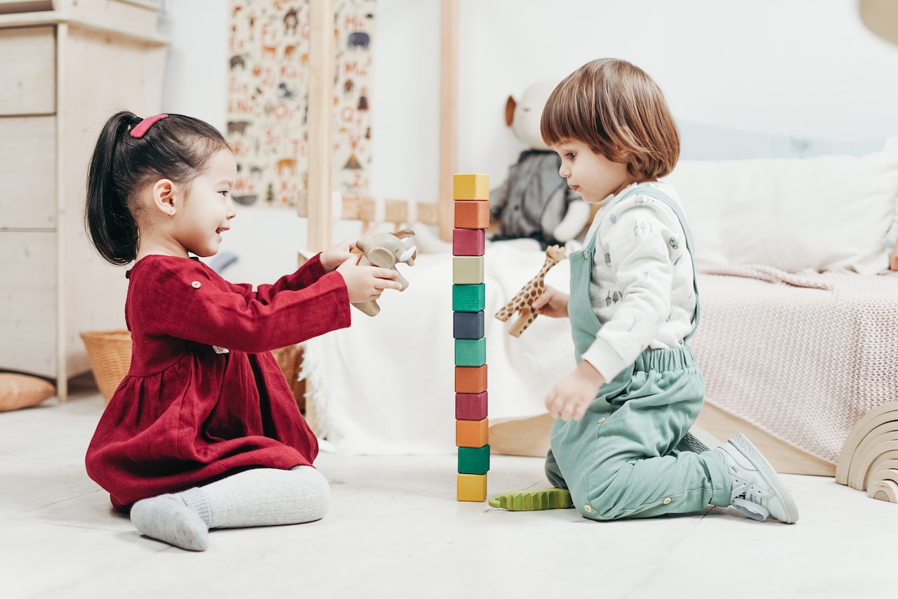 two children build a block tower